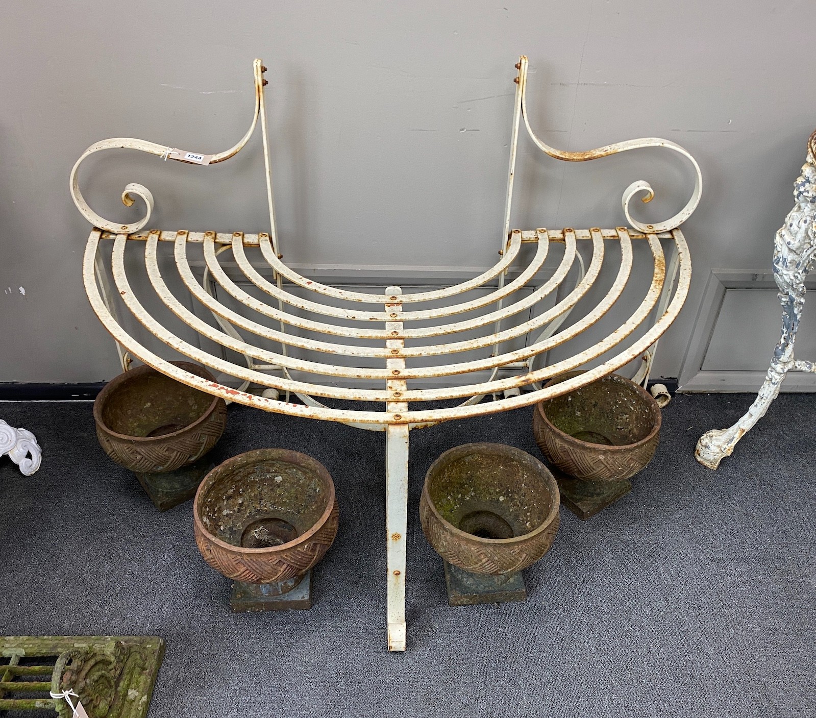 A painted wrought iron garden tree seat, width 120cm, depth 60cm